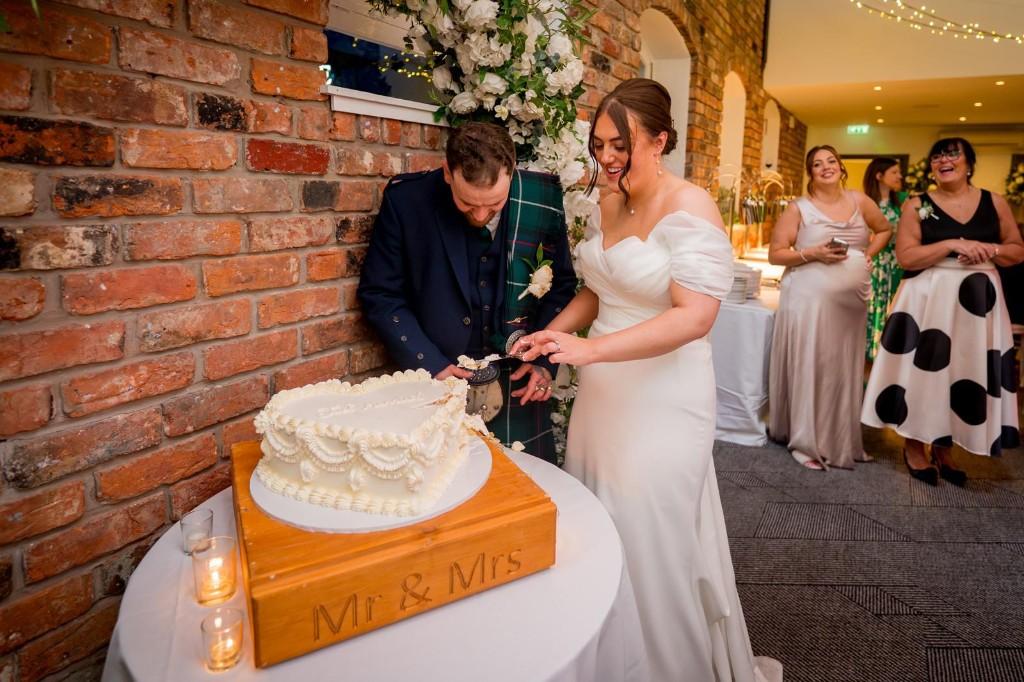 Gold candle wedding cake with soft draped backdrop