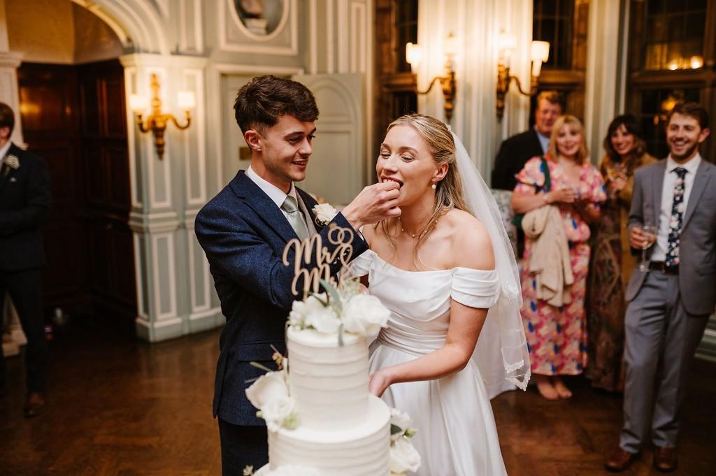 Bride and groom cutting their Abba Cakes wedding cake at an elegant reception