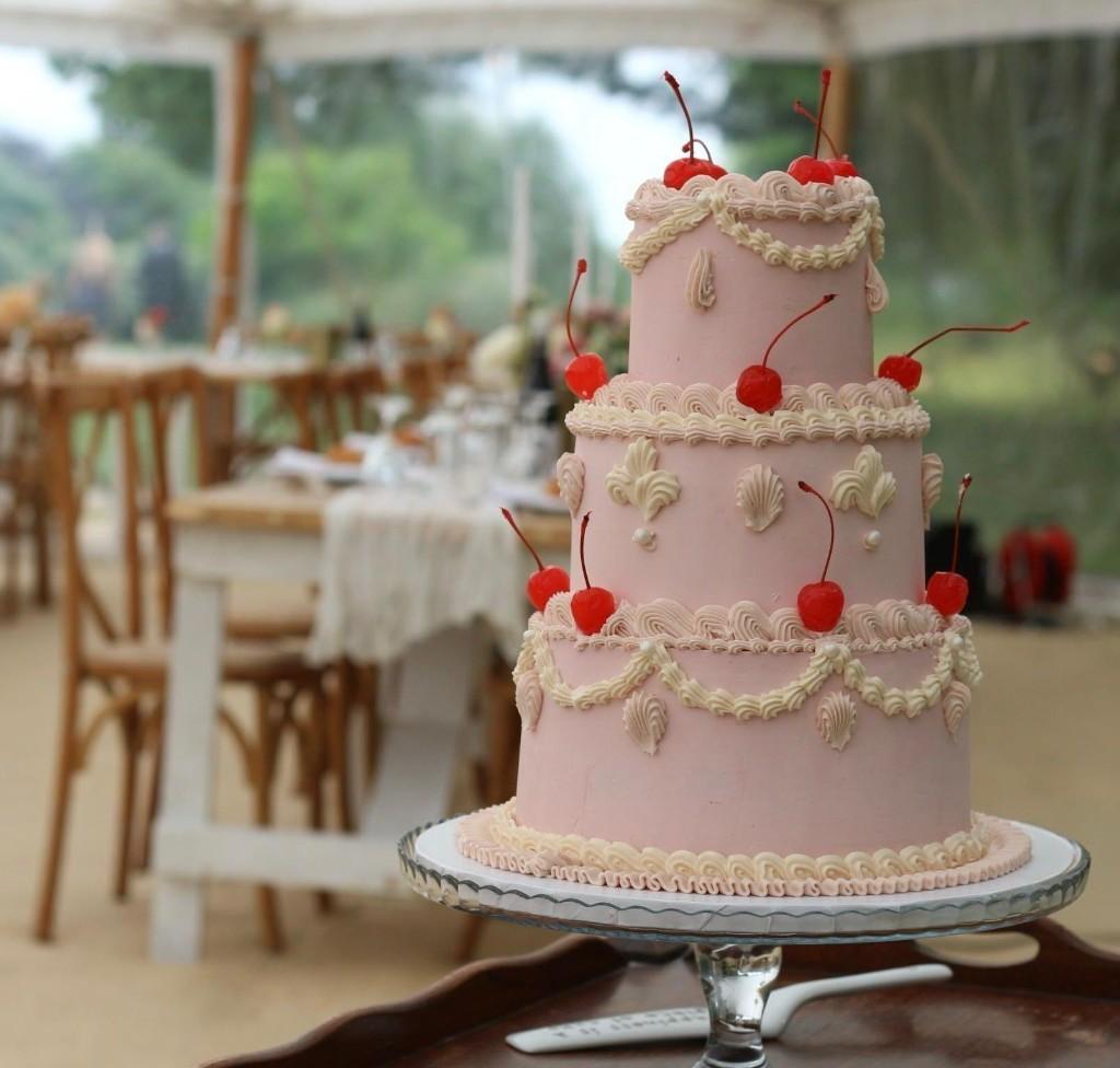 Wedding cake in a bright reception setting