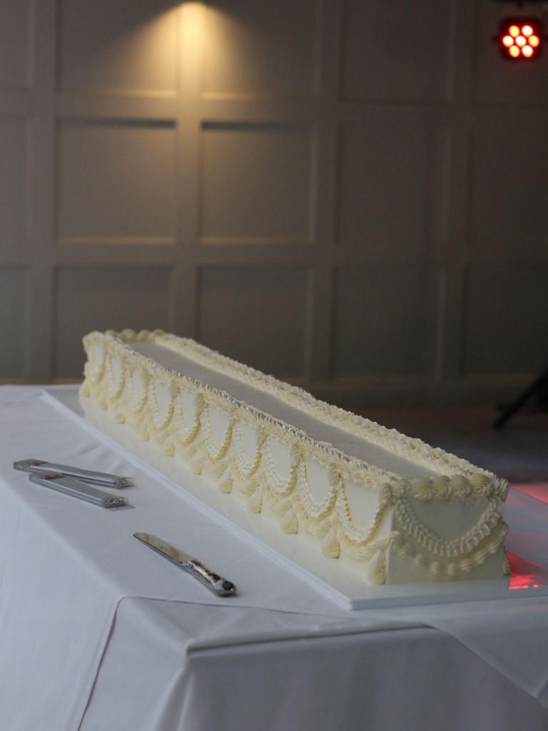 Long rectangular wedding cake with refined white piping