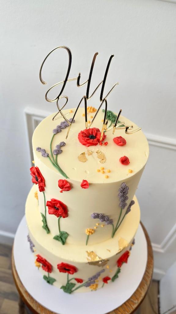 Wedding cake with cherries and vintage piping outdoors