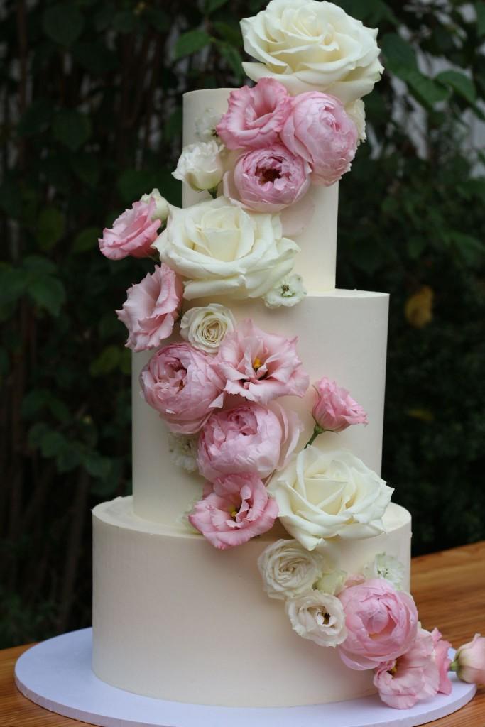 Four-tier wedding cake at a marquee celebration